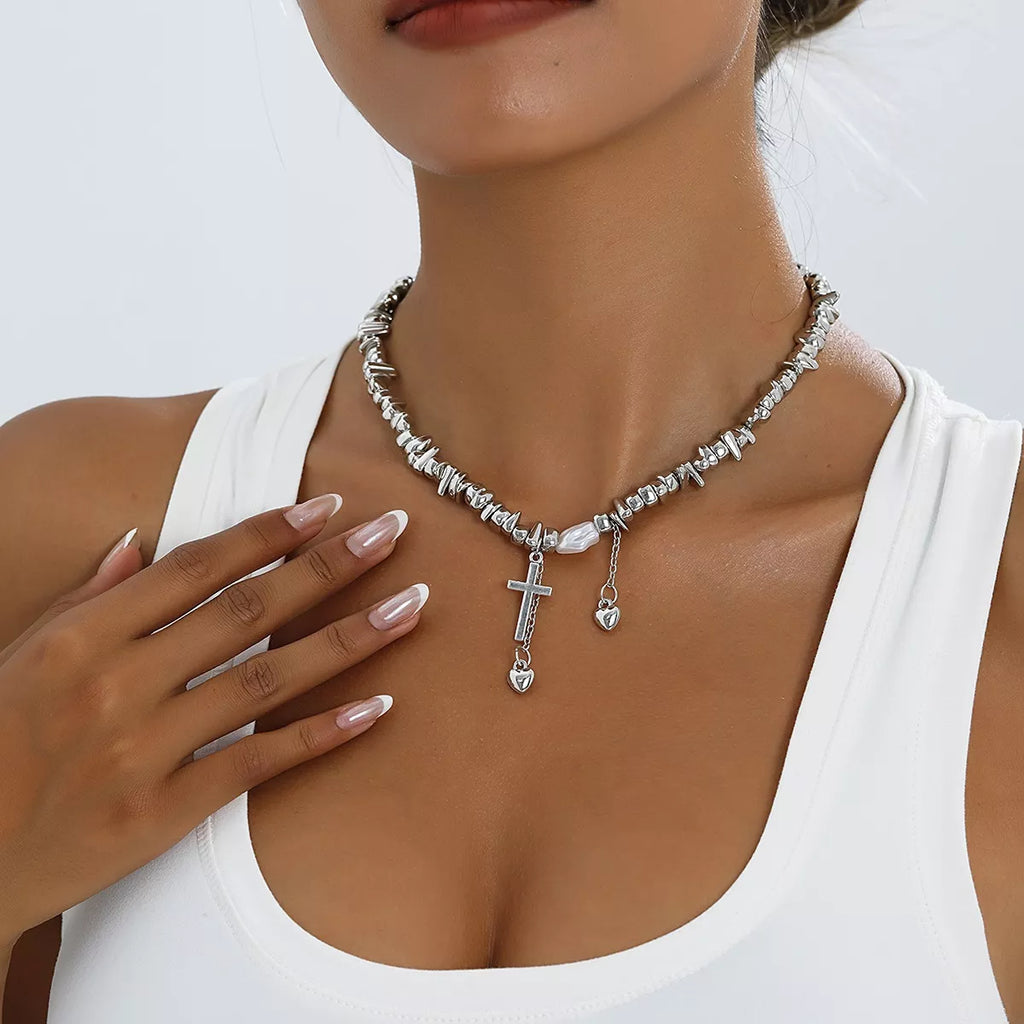 Chunky silver-tone chain necklace with cross and dangling charms