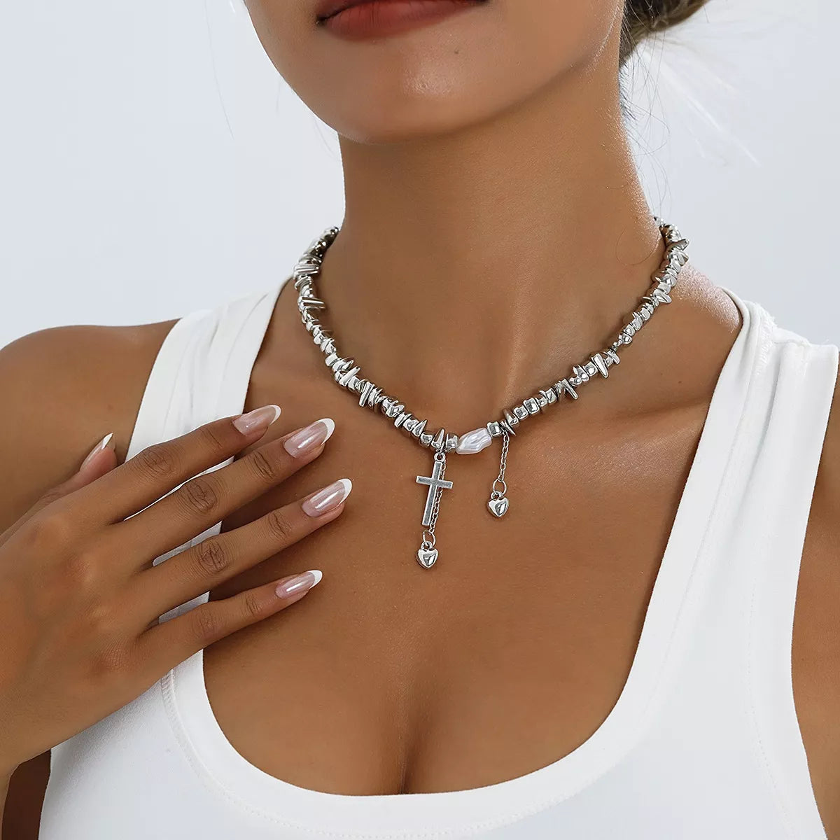 Chunky silver-tone chain necklace with cross and dangling charms