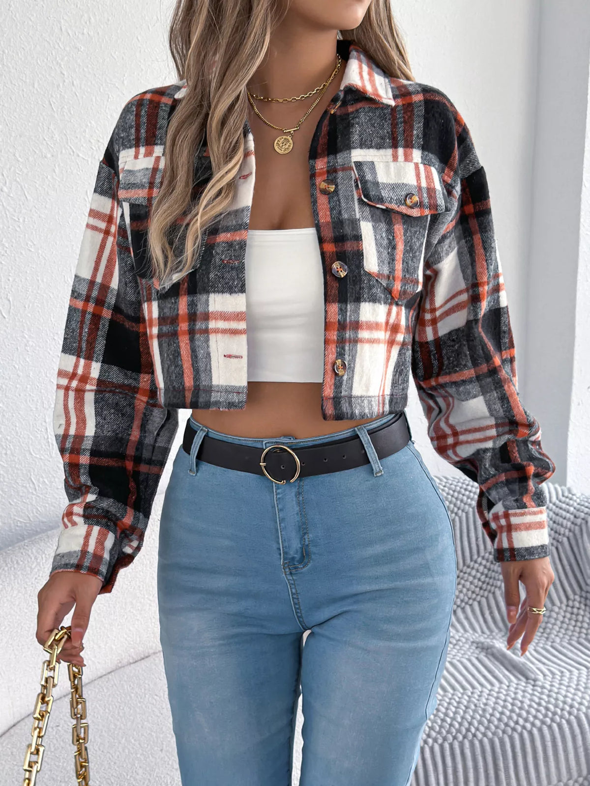 Black plaid cropped jacket modeled over a white top.