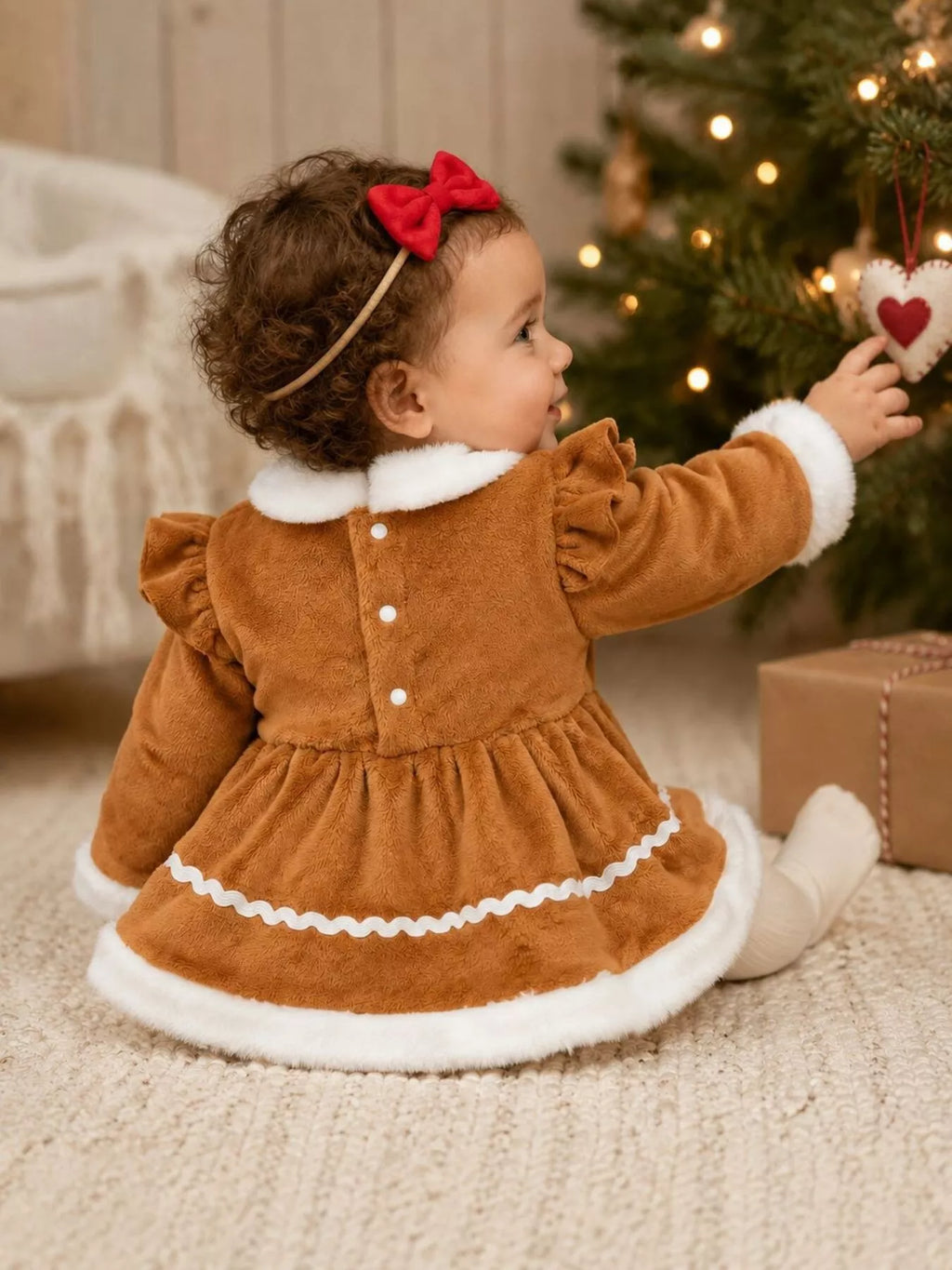 Back view of the brown baby dress with white collar, trim and button fastening.