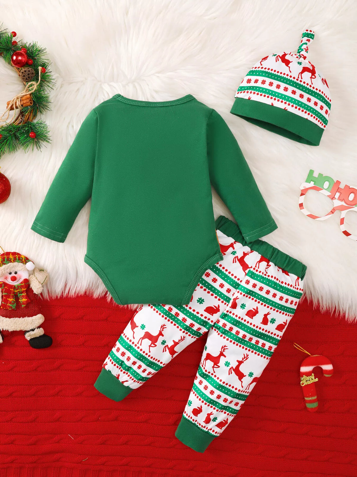 Back flat lay of the green bodysuit, Christmas-patterned pants and matching hat.