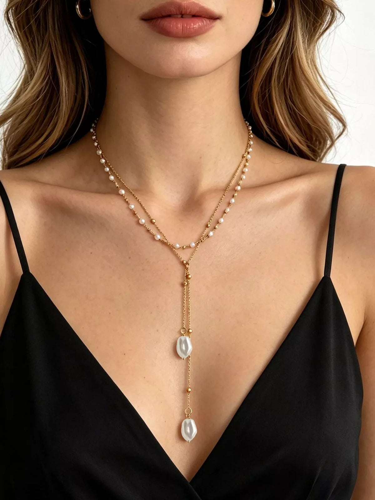 Gold-tone layered Y-shaped necklace with pearl-like pendants