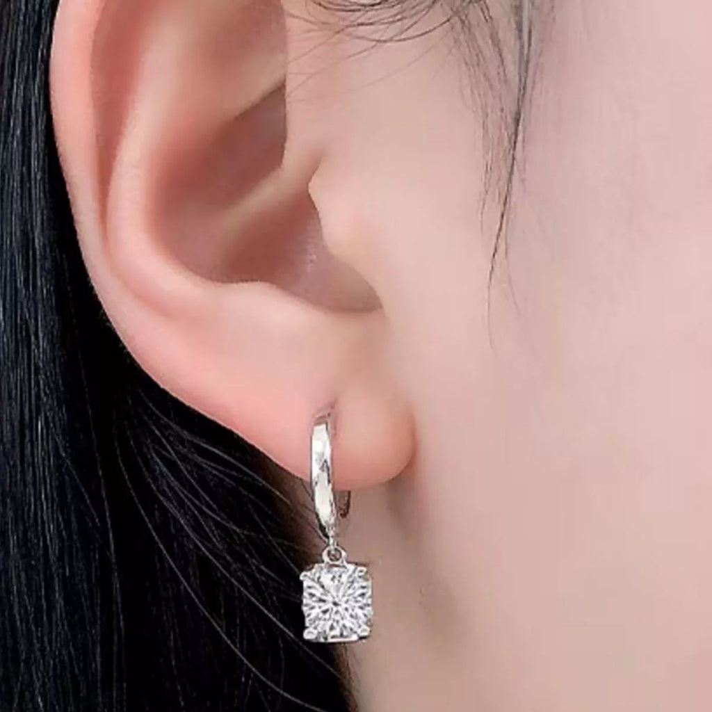Silver-tone hoop earrings with square clear stone drops — detail view