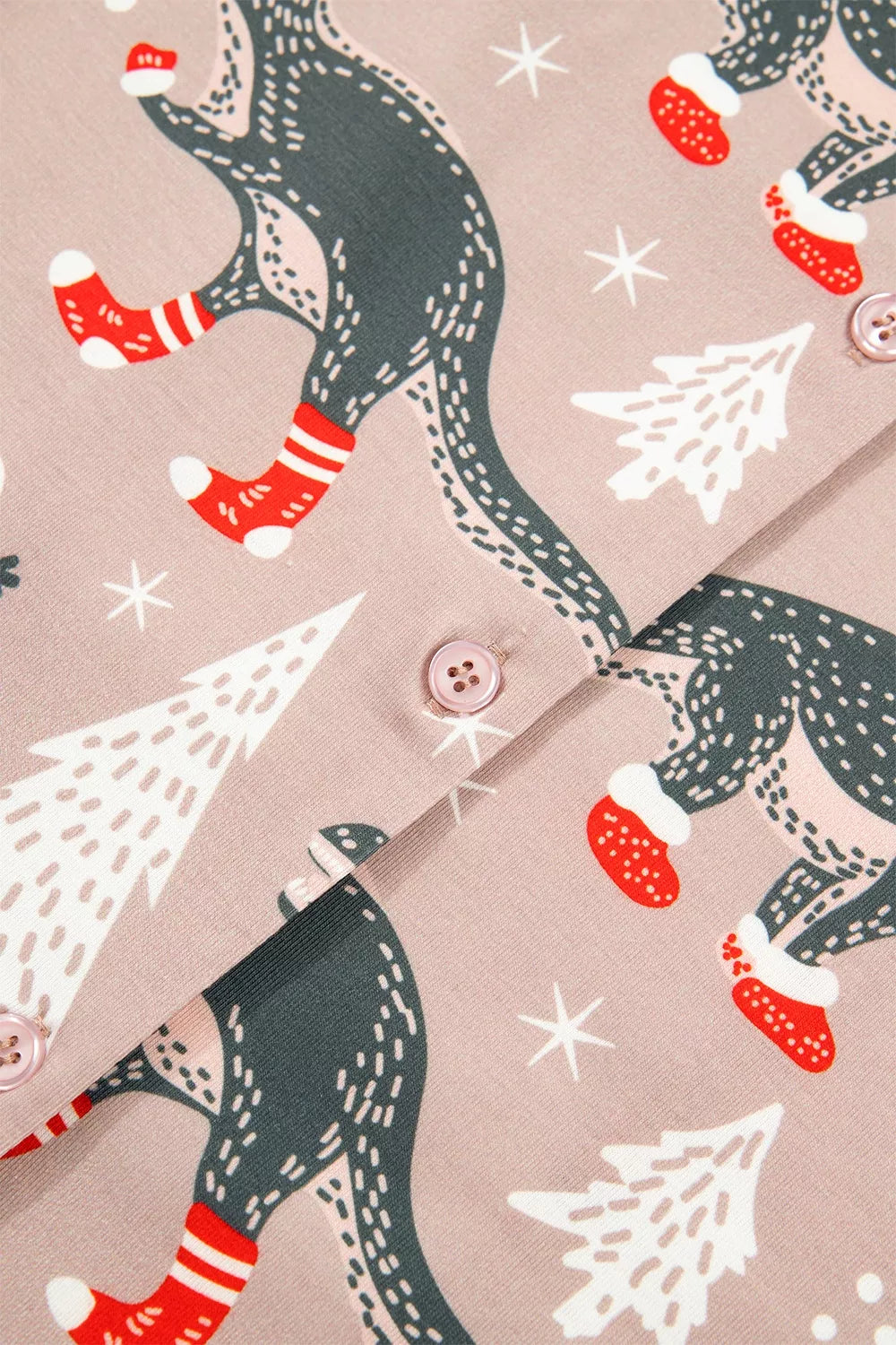 Pink long-sleeve pajama shirt and pants with dinosaur Christmas print — detail view