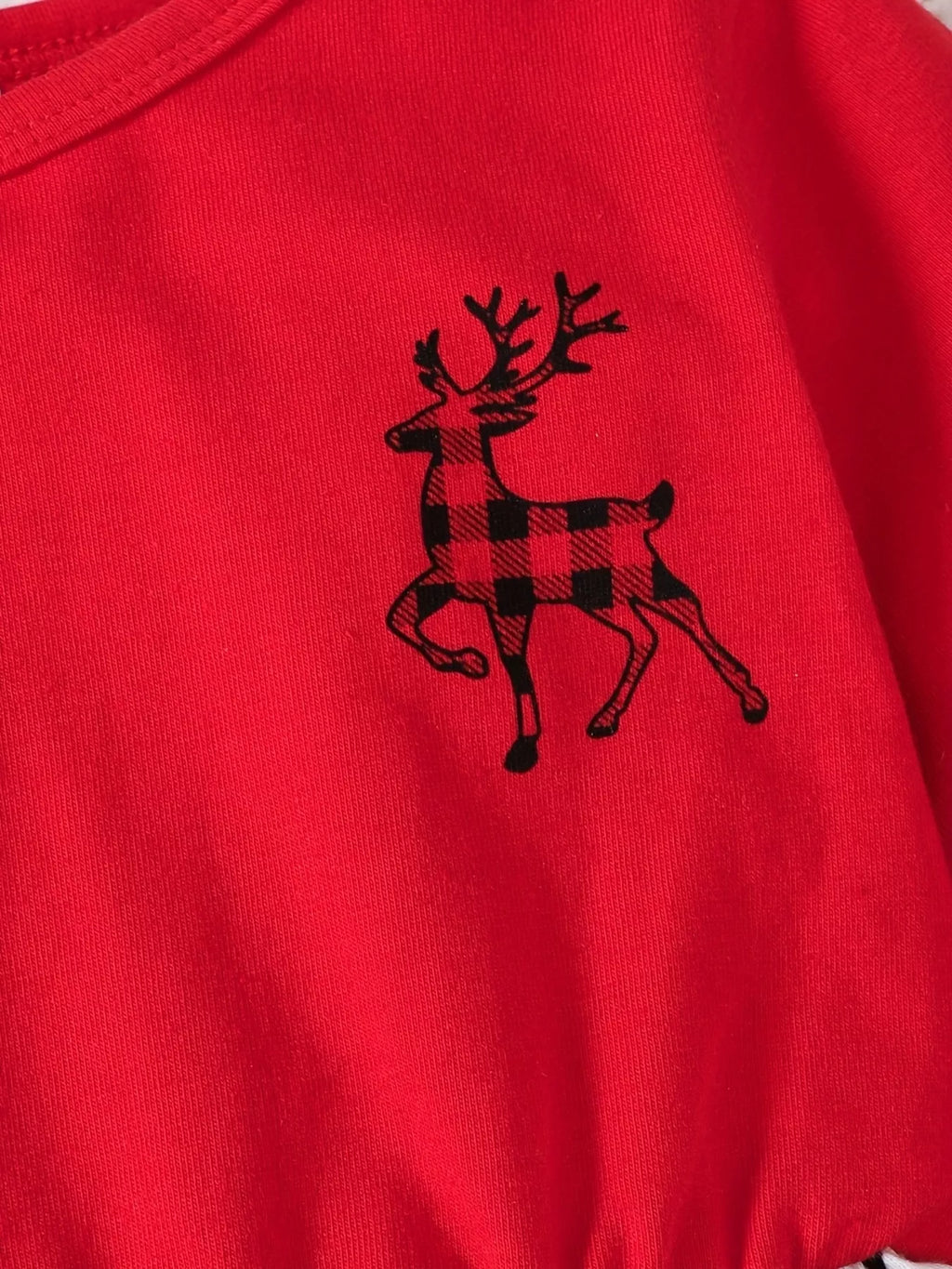 Close-up of the plaid reindeer graphic on the red Christmas dress bodice.
