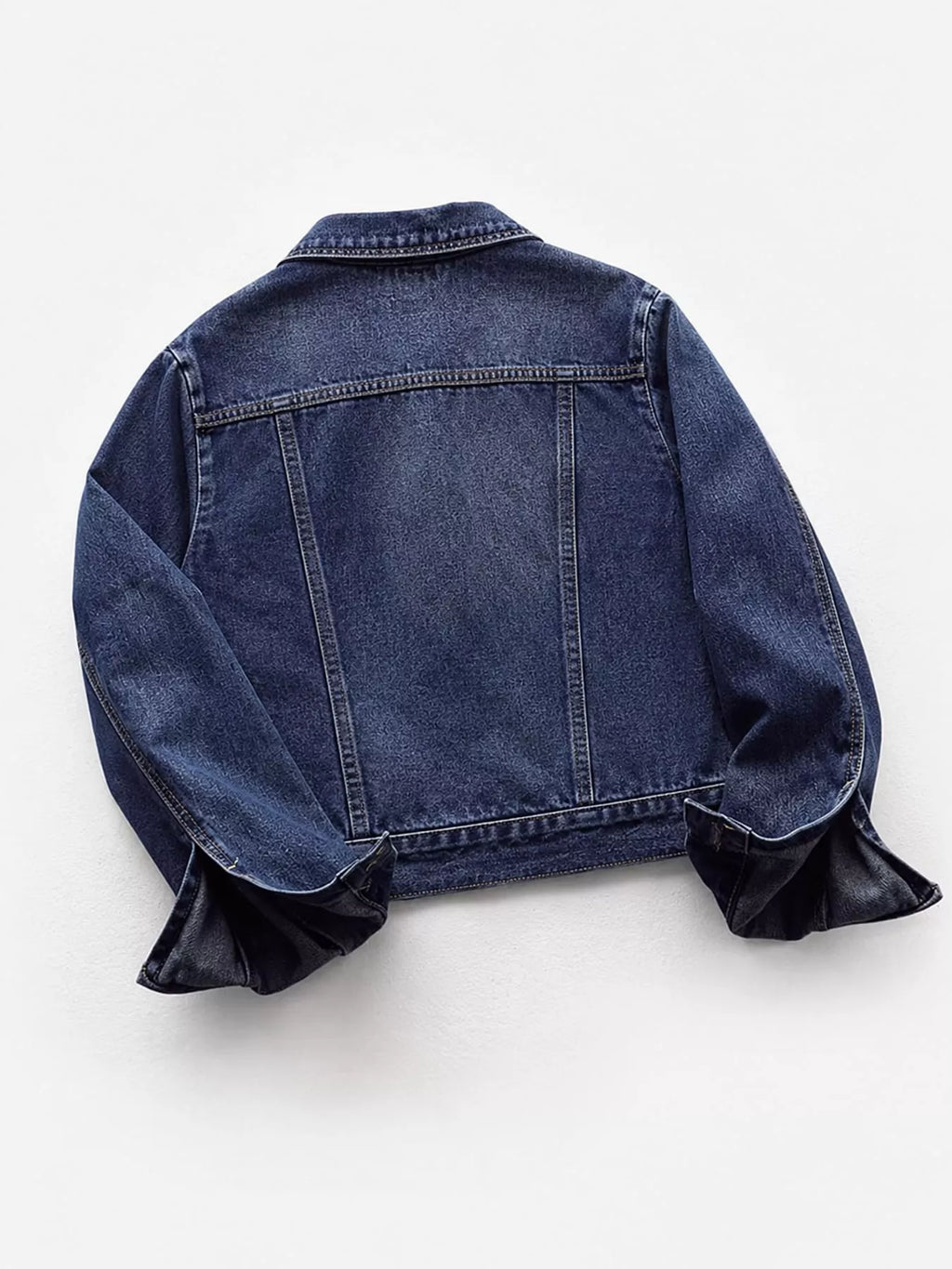 Back view of the medium-wash denim jacket.