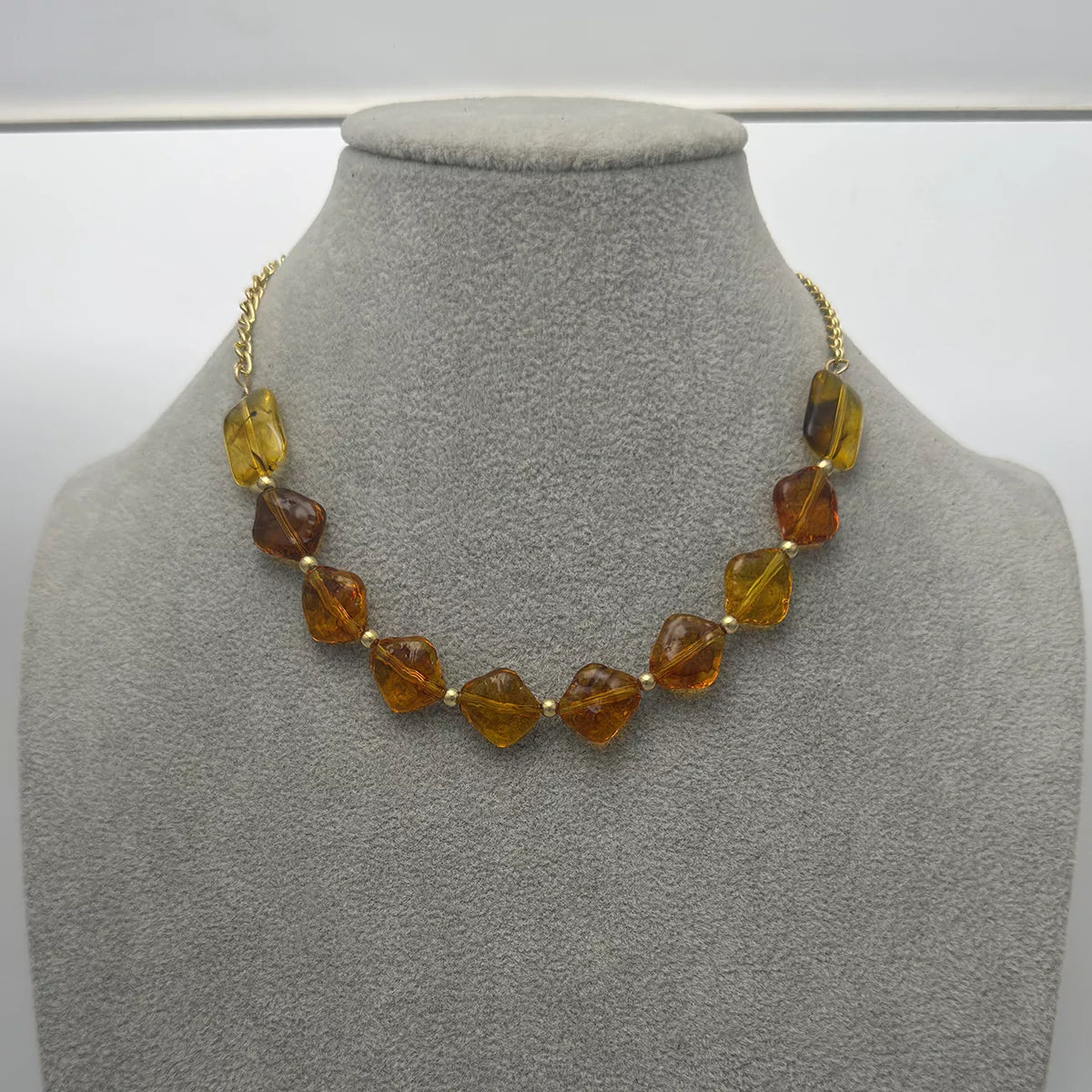 Gold-tone necklace with angular amber-colored beads