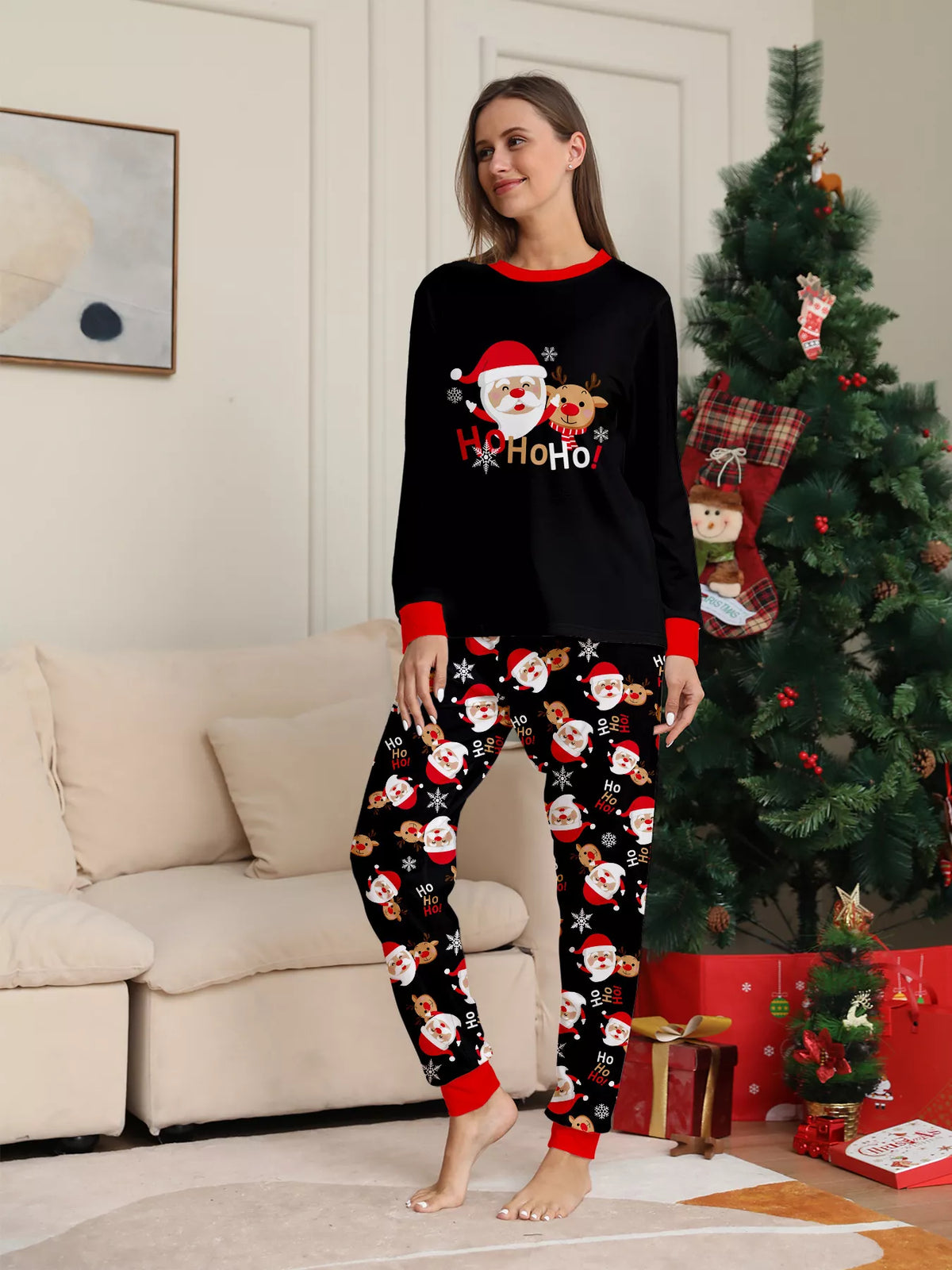 Front view of the women's black Santa graphic pajamas.