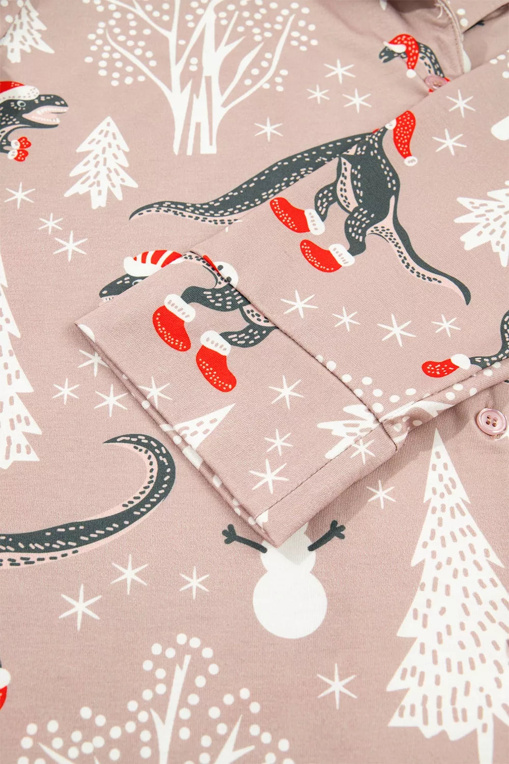 Pink long-sleeve pajama shirt and pants with dinosaur Christmas print — detail view