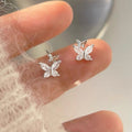 Silver-tone butterfly stud earrings with clear stones — detail view
