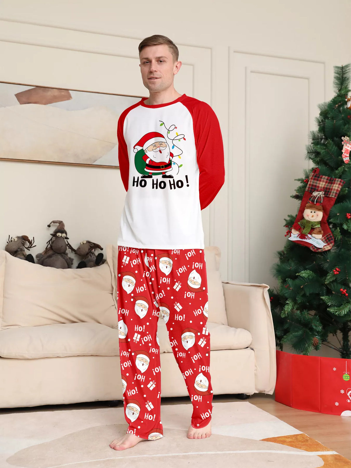 Man wearing the white Ho Ho Ho Santa top and red printed pajama pants.