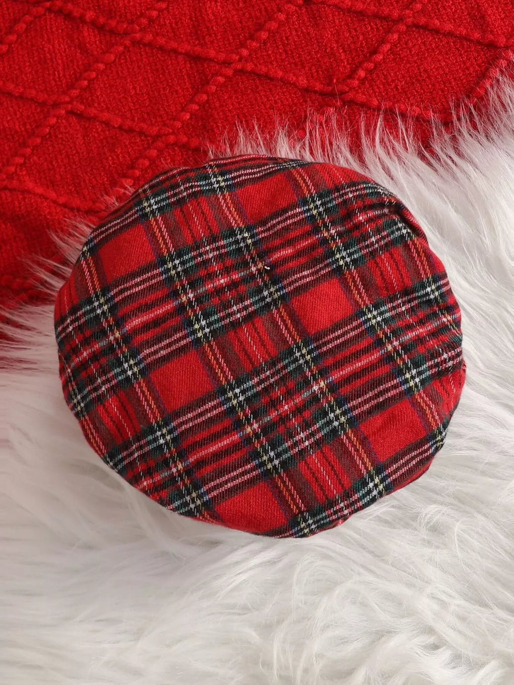 Close-up of the red tartan plaid beret.