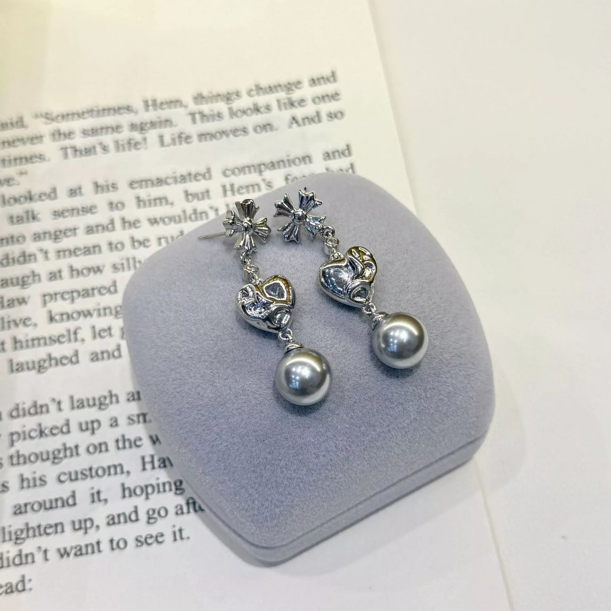 Heart-shaped drop earrings with gray pearl-like beads