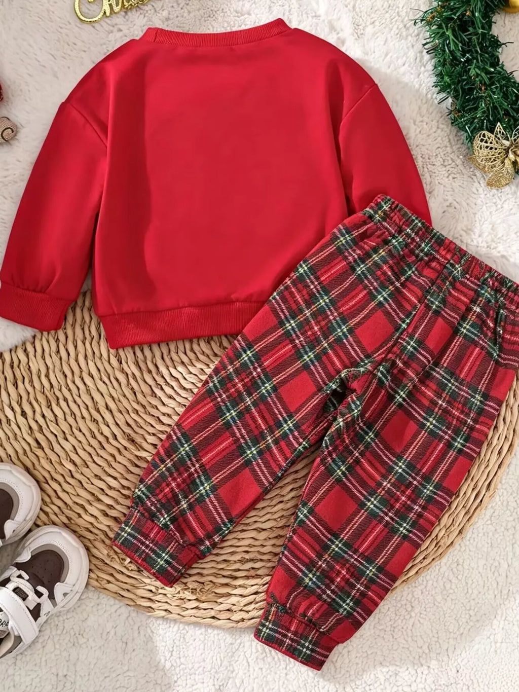 Children’s red Santa graphic sweatshirt and red plaid pants — back view