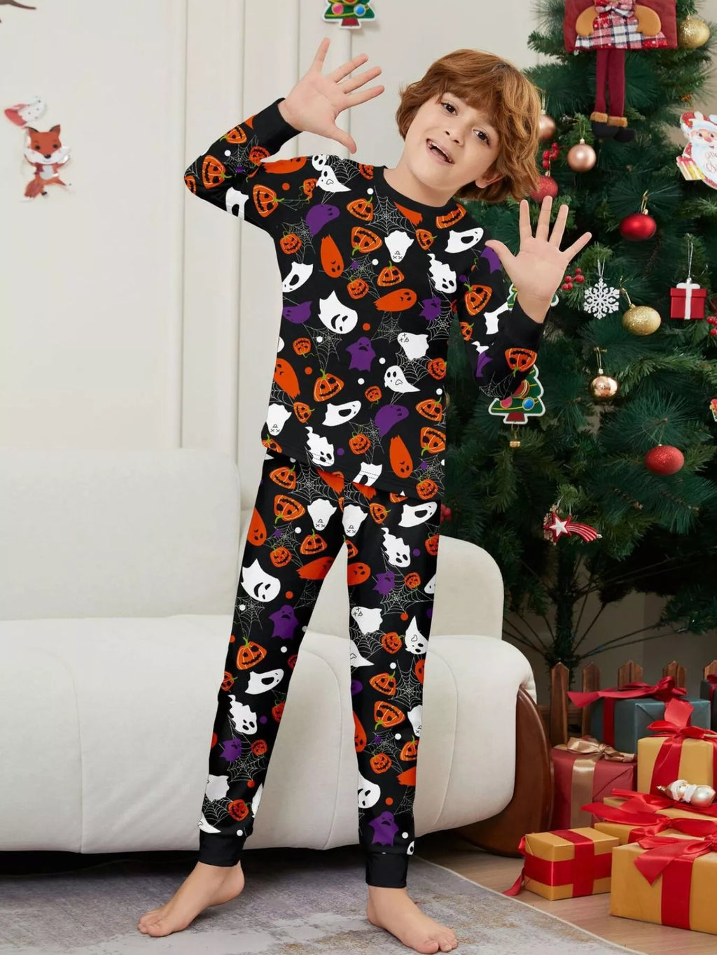 Black matching family pajamas with colorful Halloween ghost and pumpkin print worn by a child