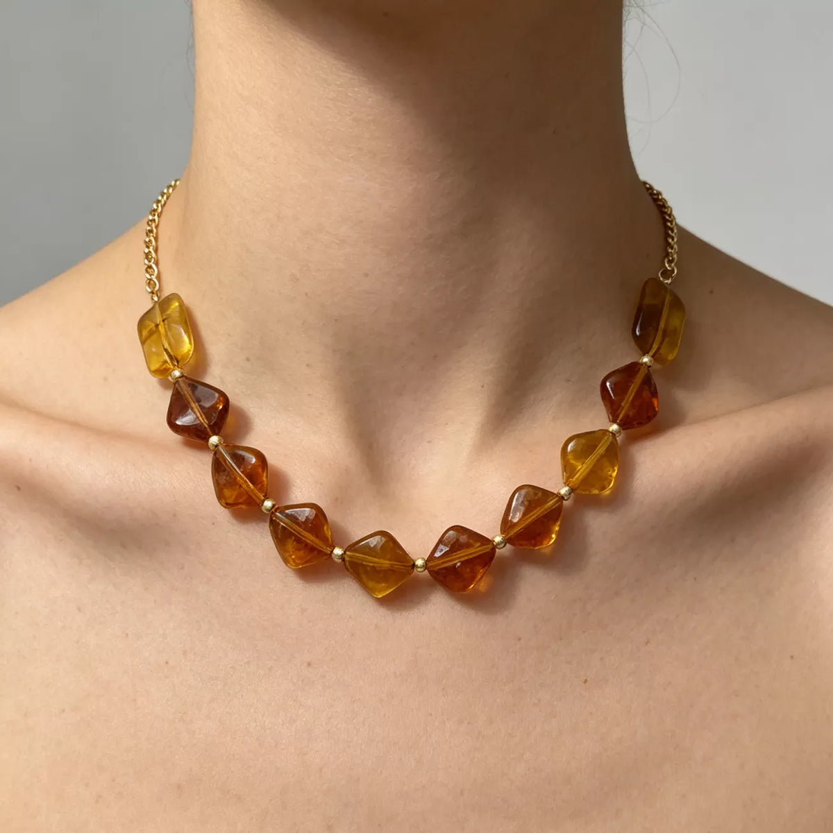 Gold-tone necklace with angular amber-colored beads