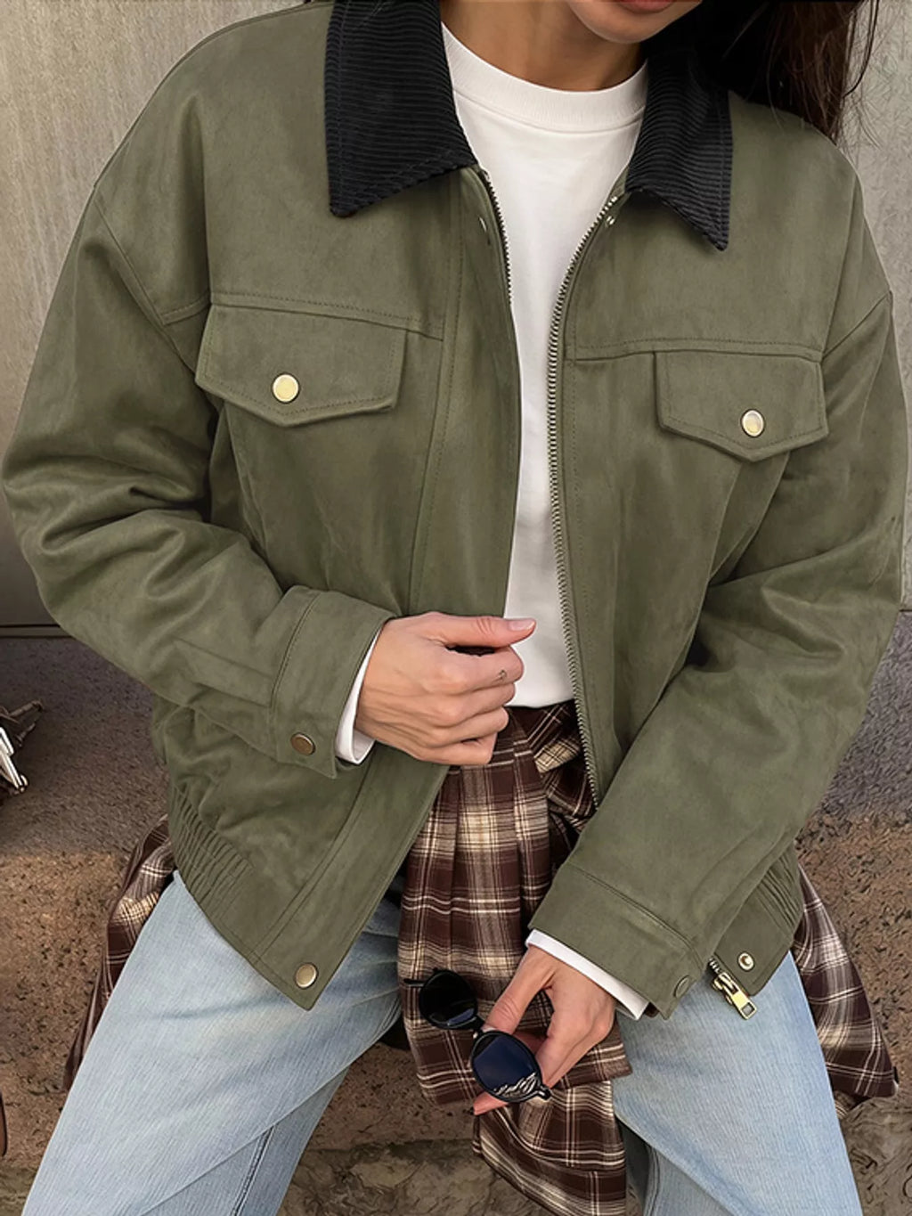 Front view of the army-green zip-up jacket and flap chest pockets.