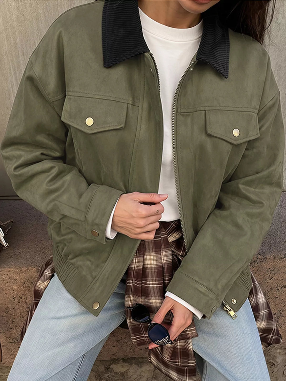 Front view of the army-green zip-up jacket and flap chest pockets.