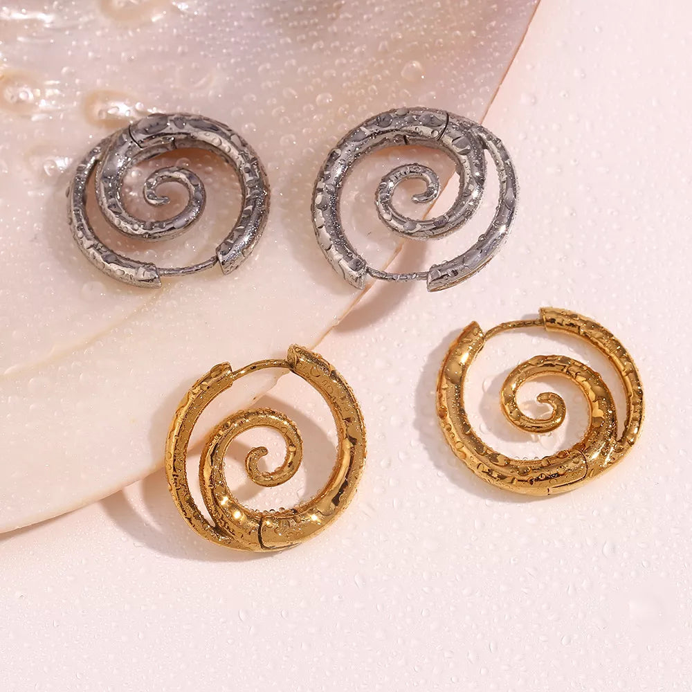 Spiral hoop earrings in gold-tone and silver-tone finishes — detail view
