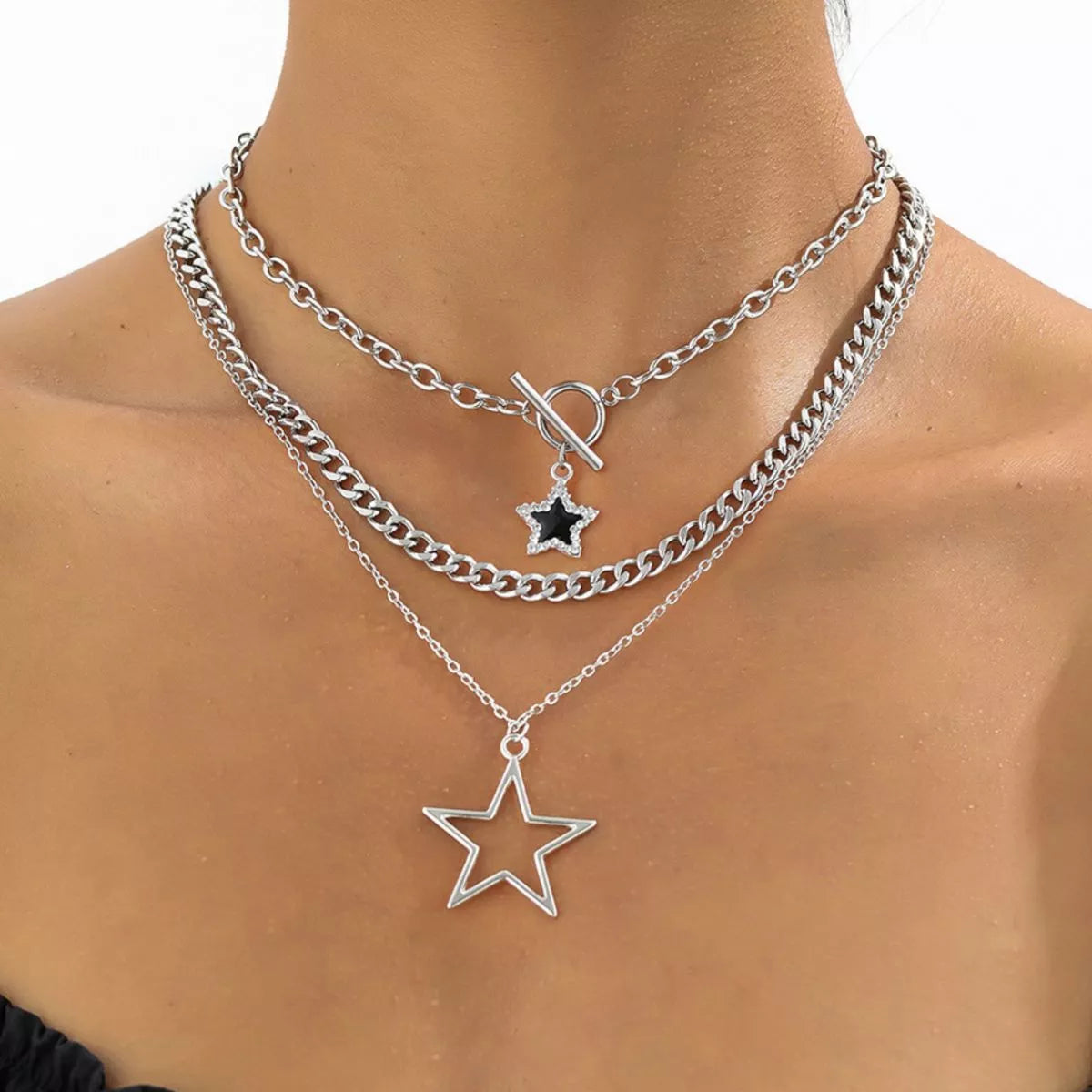 Three layered silver-tone necklaces with star pendants