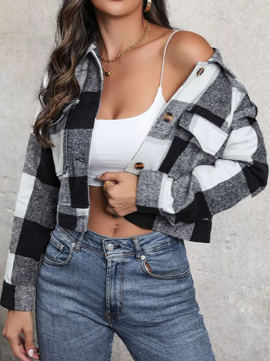 Gray color-block plaid cropped jacket with flap chest pockets, worn open over a white top.