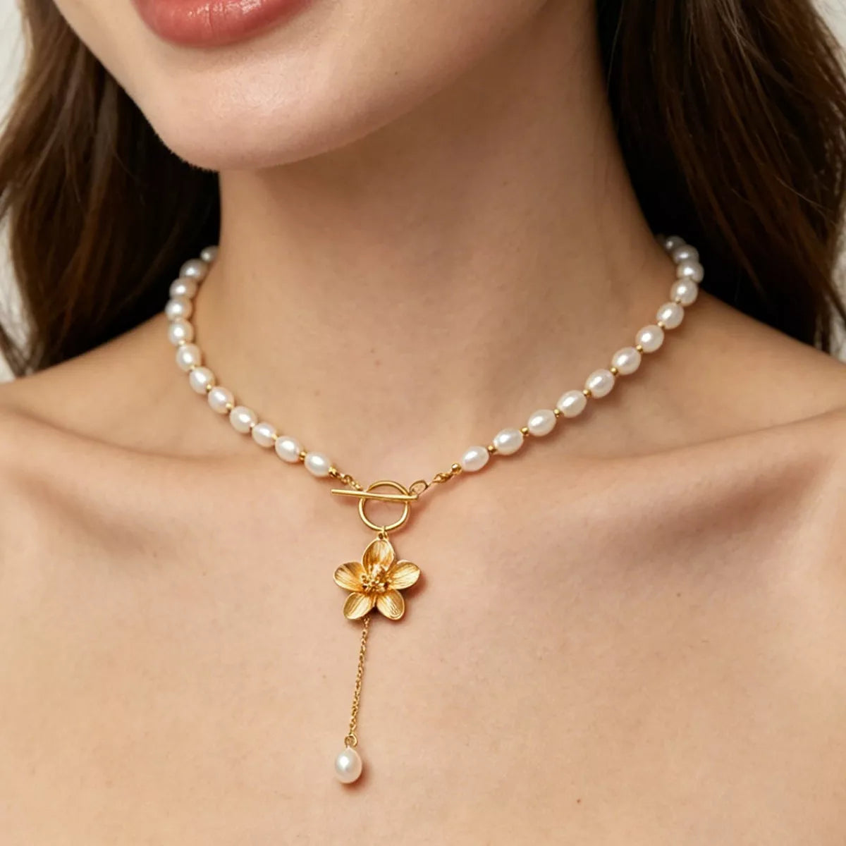 Pearl-like bead choker with gold-tone flower clasp and long pendant