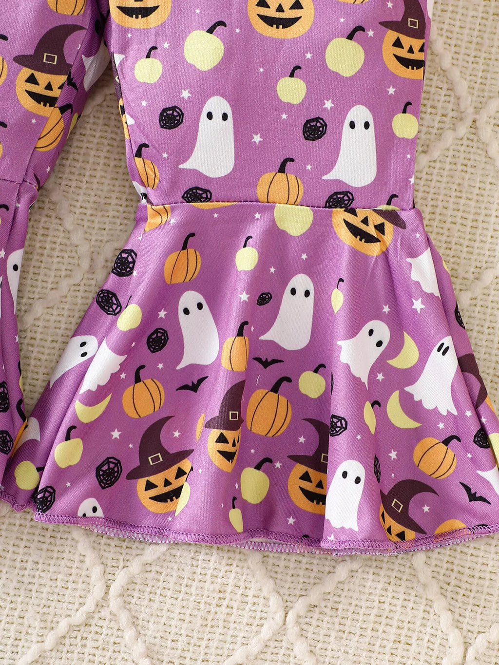 Close-up of the purple Halloween overalls' gathered waist and flared leg.