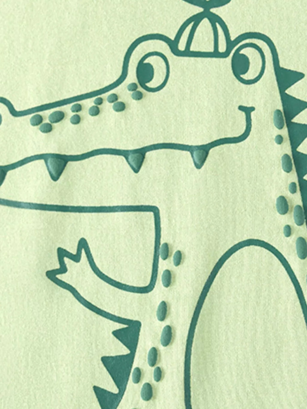 Crocodile wearing a pumpkin on its head printed on the light green T-shirt