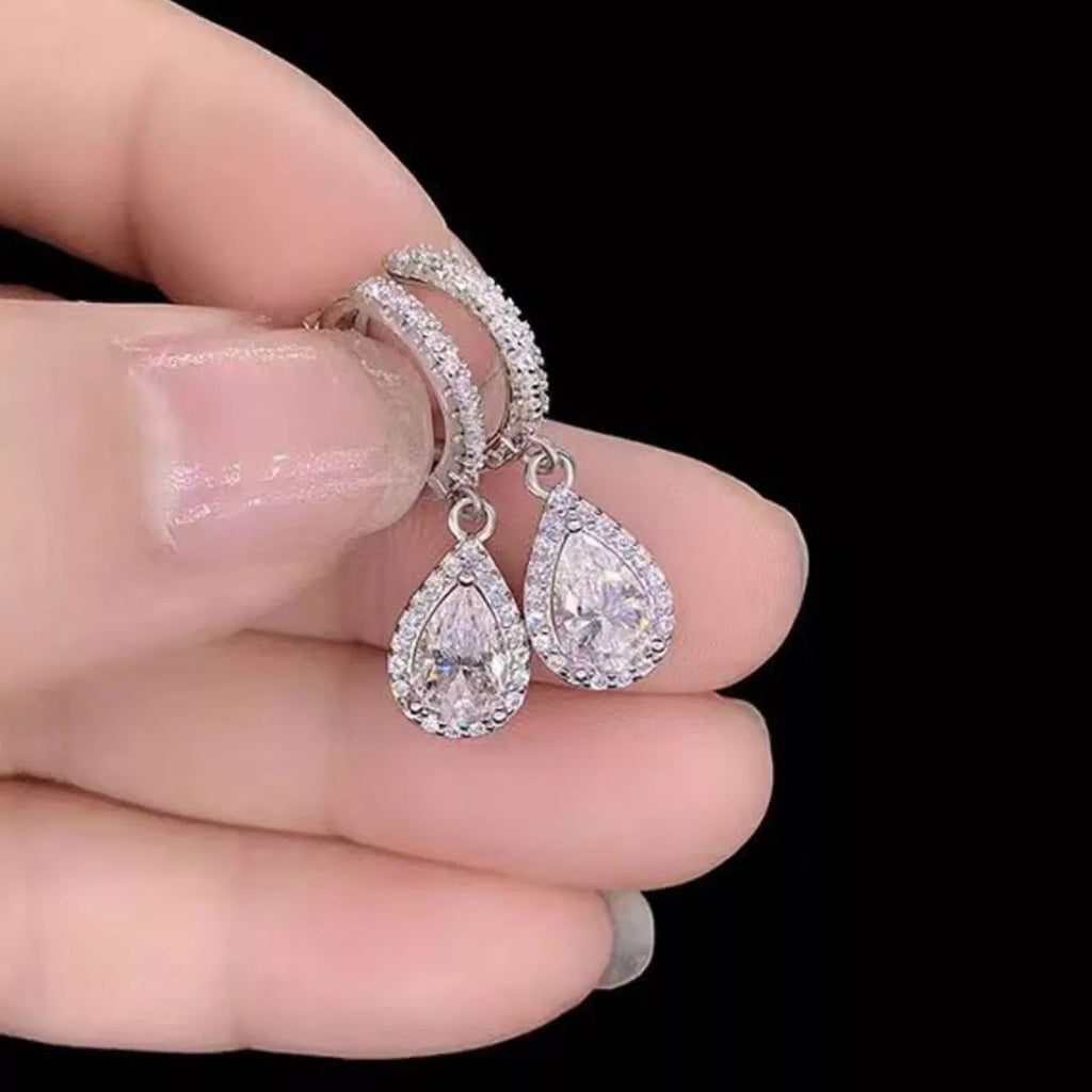 Silver-tone hoop earrings with teardrop halo stone drops — detail view