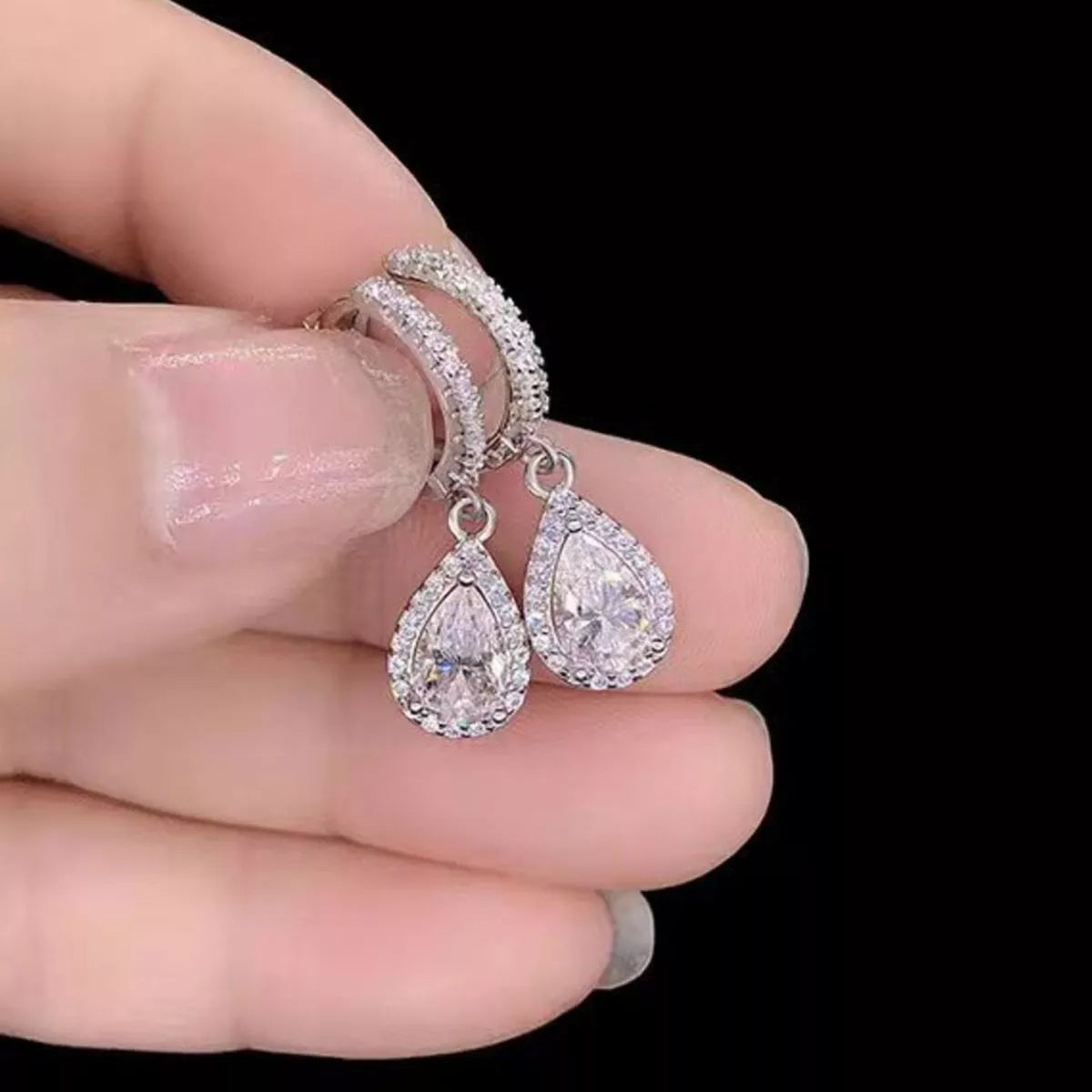Silver-tone hoop earrings with teardrop halo stone drops — detail view