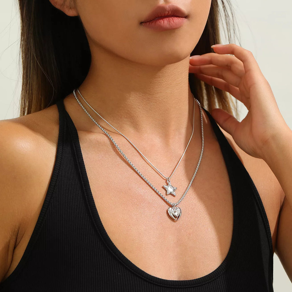 Layered silver-tone star and heart pendant necklaces