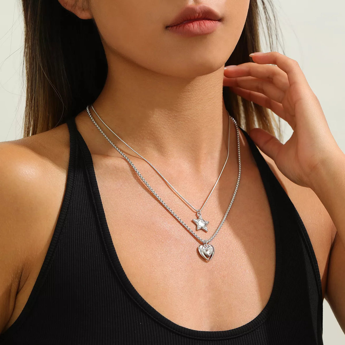 Layered silver-tone star and heart pendant necklaces