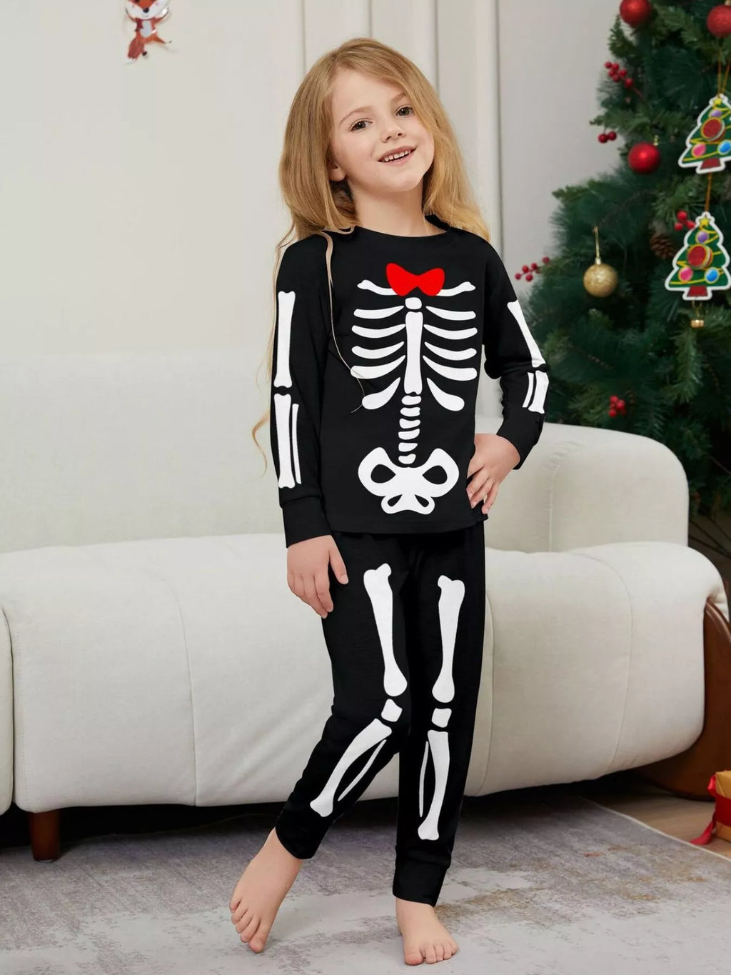 Child wearing black and white skeleton-print pajamas.