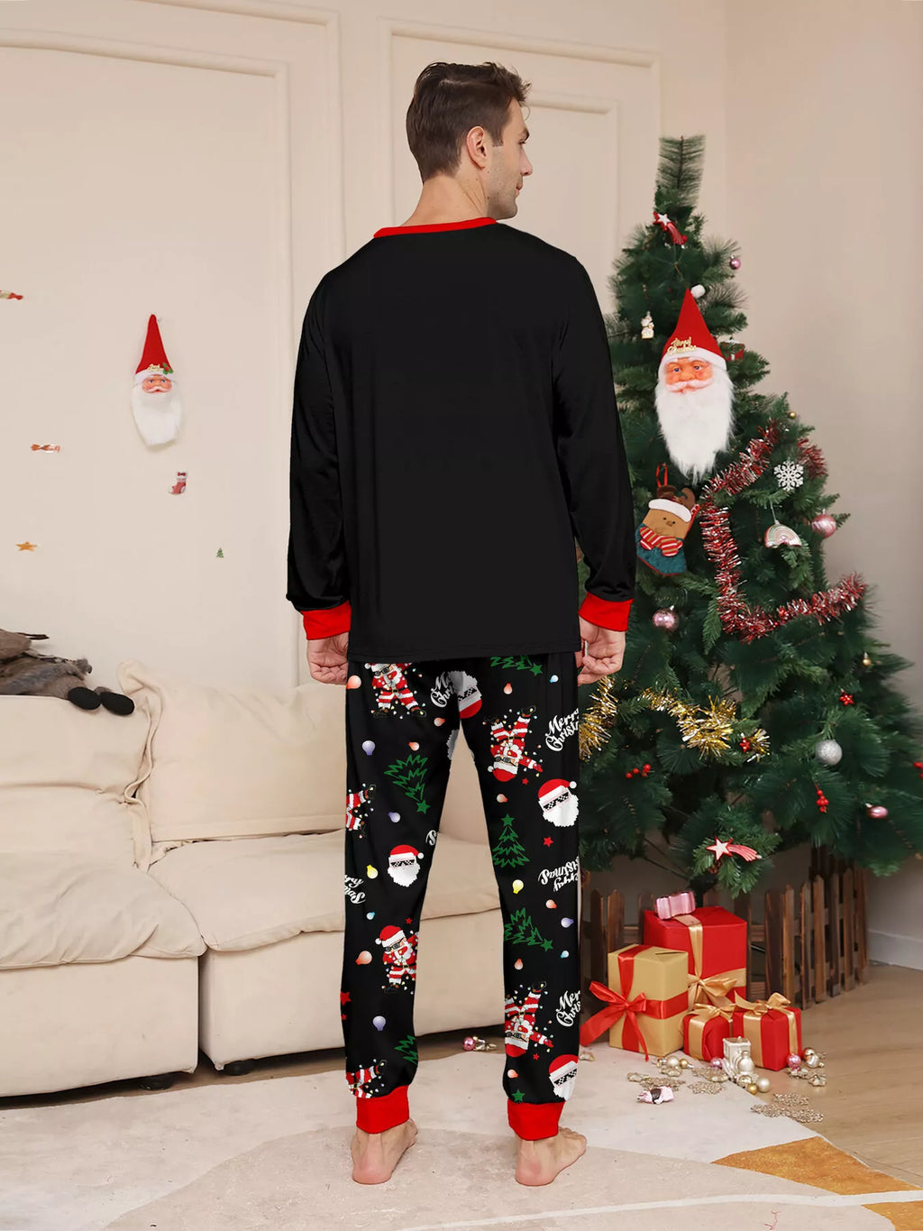 Back view of the men's black top and Christmas-print pajama pants.