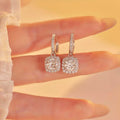 Silver-tone hoop earrings with square halo stone drops — detail view