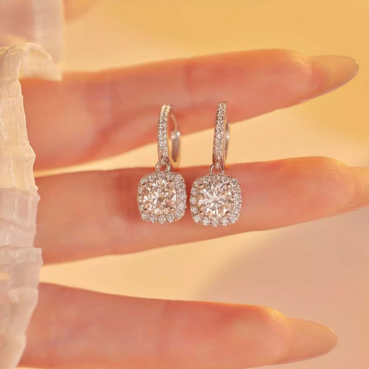 Silver-tone hoop earrings with square halo stone drops — detail view