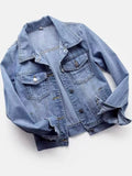 Light-wash button-front denim jacket displayed with chest pockets and rolled cuffs.