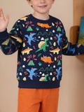 Child wearing a navy sweatshirt with colorful dinosaurs and orange pants.