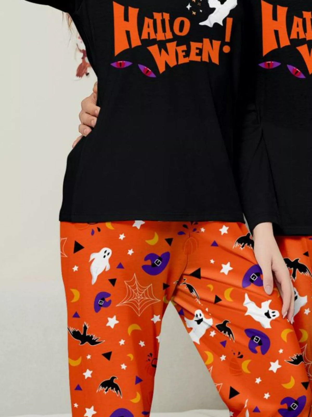 Close-up of the matching black Halloween tops and orange pajama waistbands.
