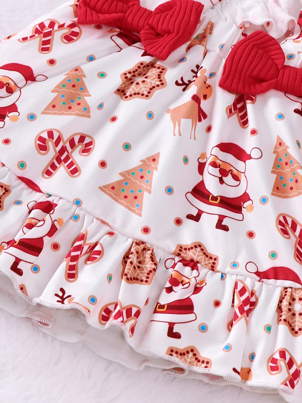 Close-up of the Santa-print suspender skirt and red bow.