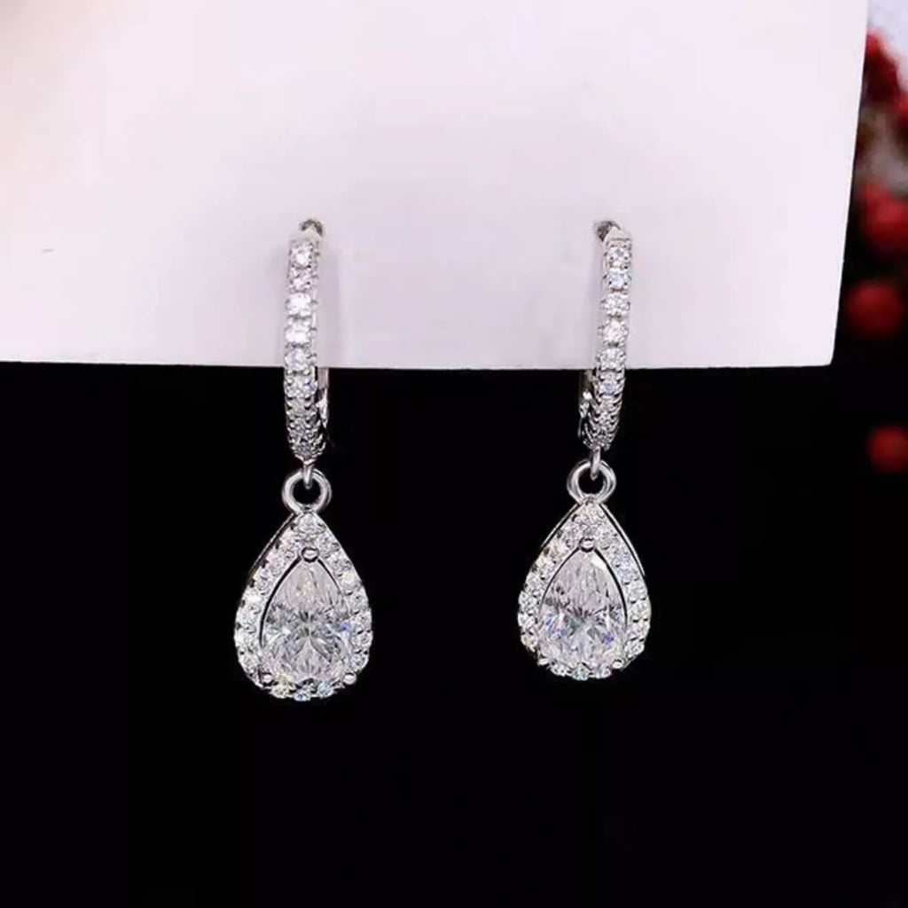 Silver-tone hoop earrings with teardrop halo stone drops — detail view