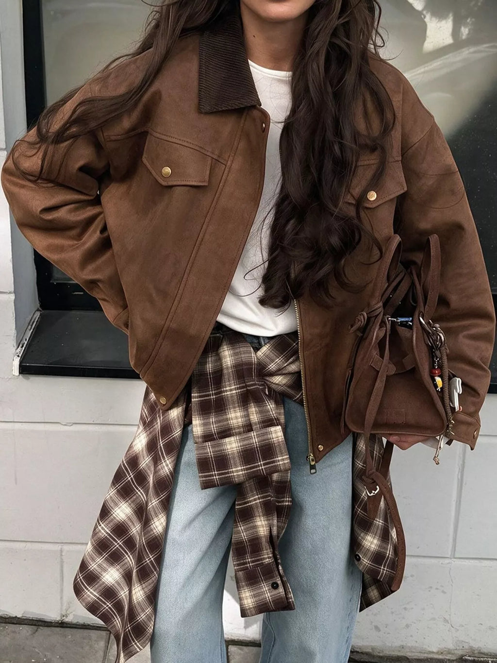 Coffee-brown dropped-shoulder jacket styled open over a white top and jeans.