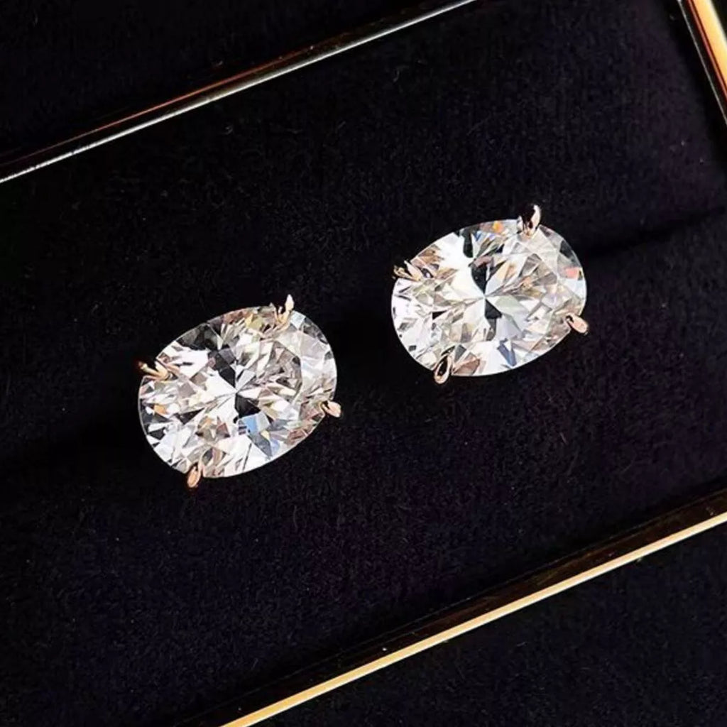 Silver-tone stud earrings with clear faceted stones — detail view