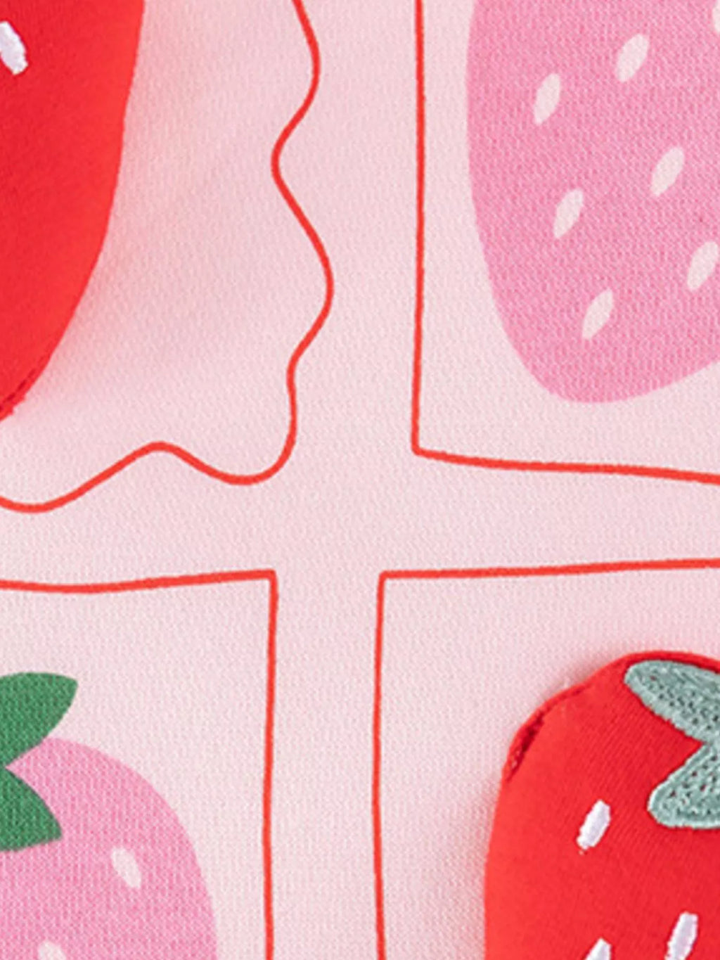 Close-up of the pink sweatshirt's red and pink strawberry print.