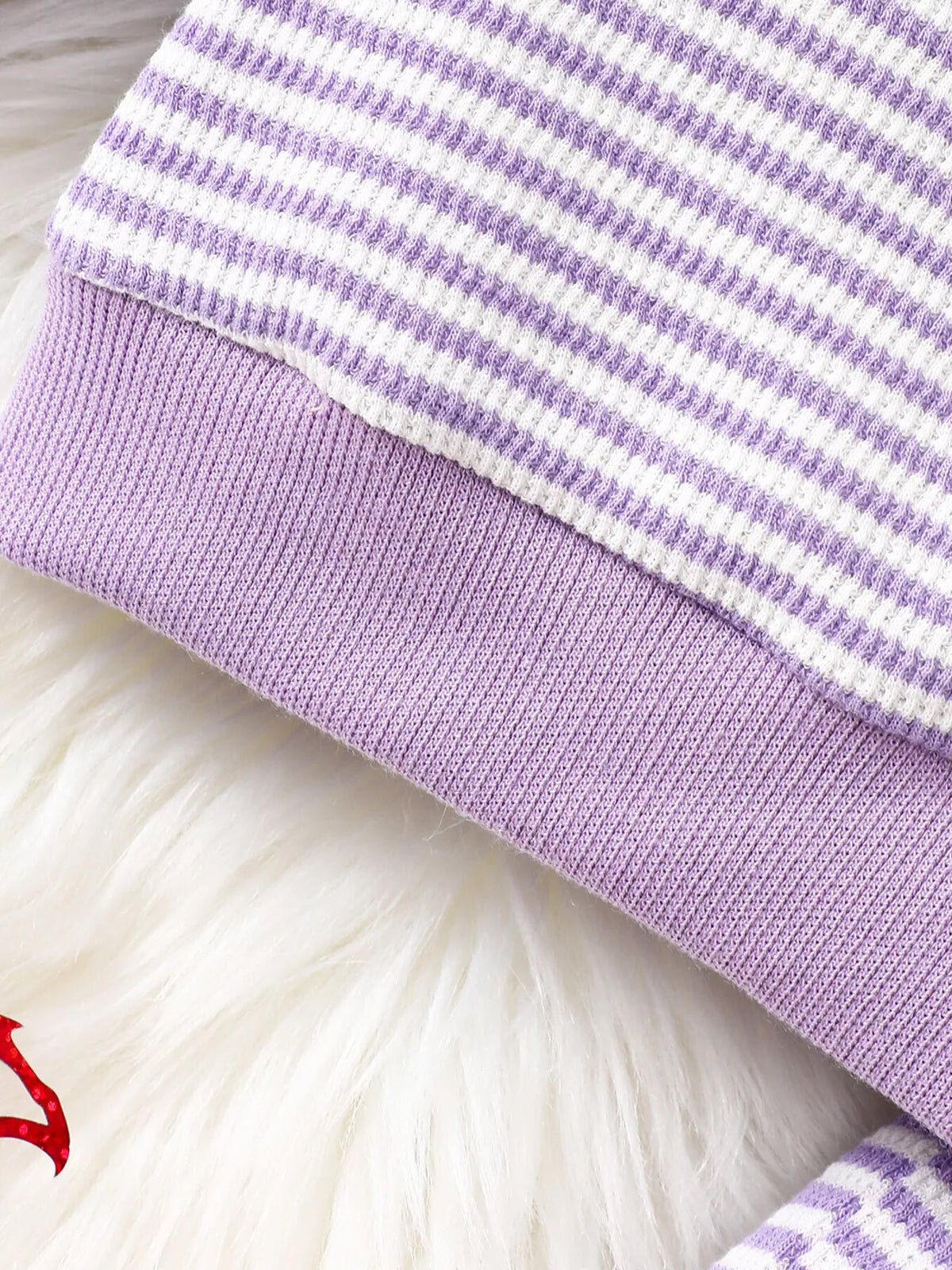 Purple ribbed cuff and striped sleeve detail