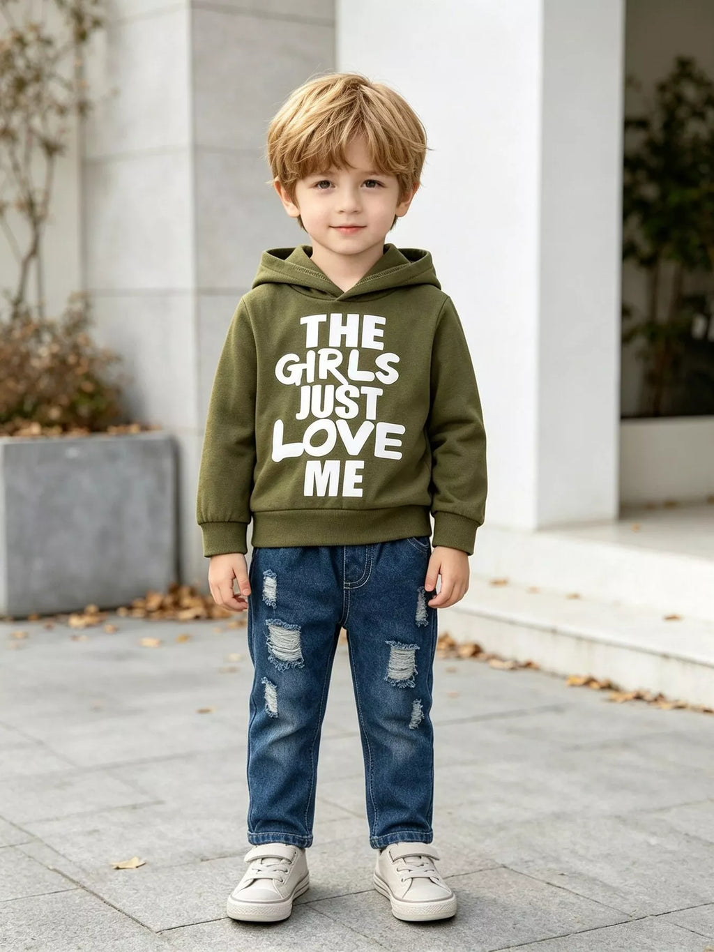 Children’s olive graphic hoodie and distressed blue jeans worn by a child
