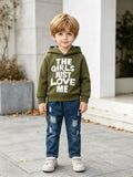 Children’s olive graphic hoodie and distressed blue jeans worn by a child