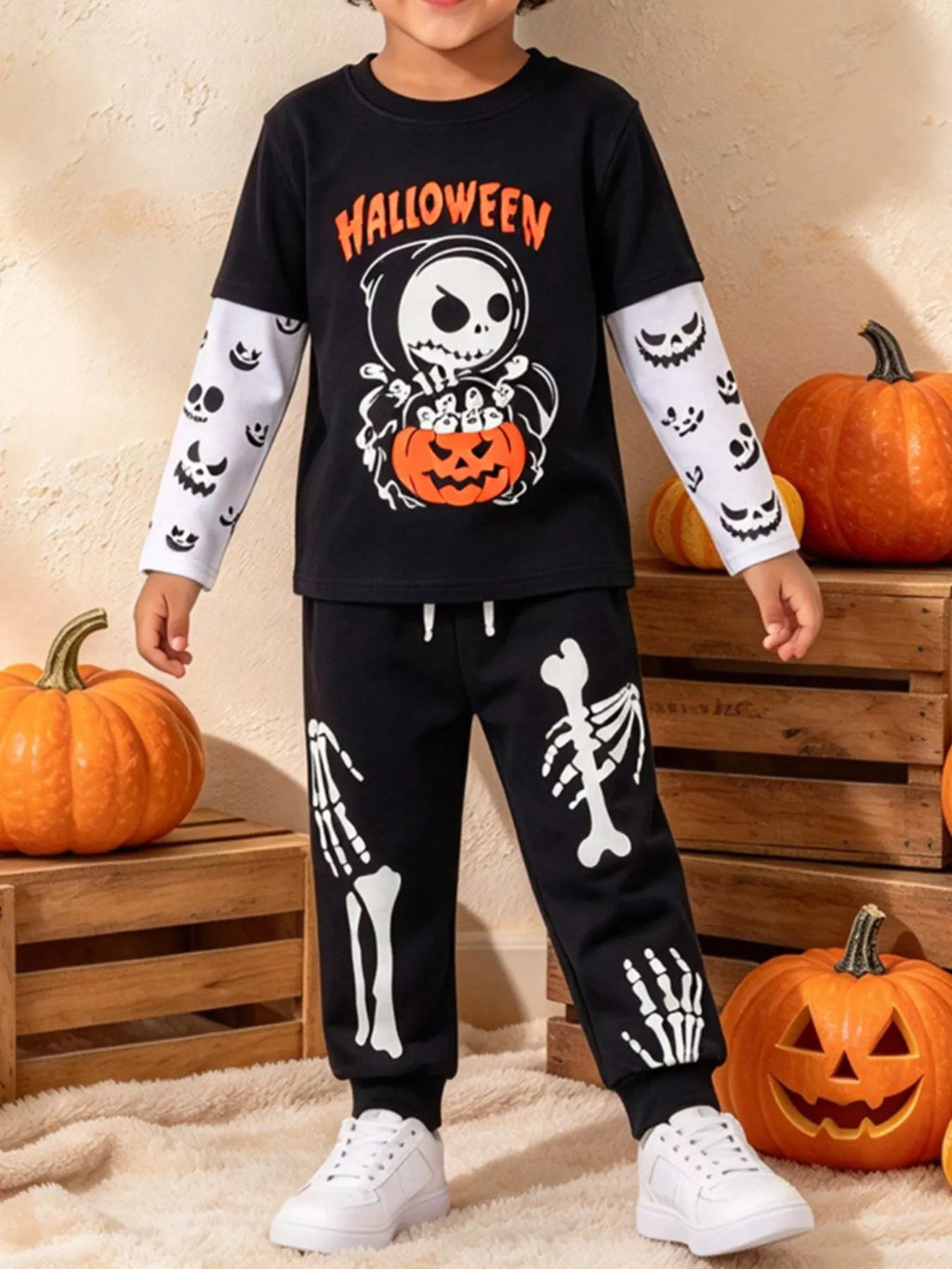 Children’s black Halloween skeleton graphic top and skeleton-print pants worn by a child