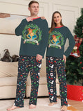 Dark green Hogwarts graphic pajama top with black patterned pants worn by an adult