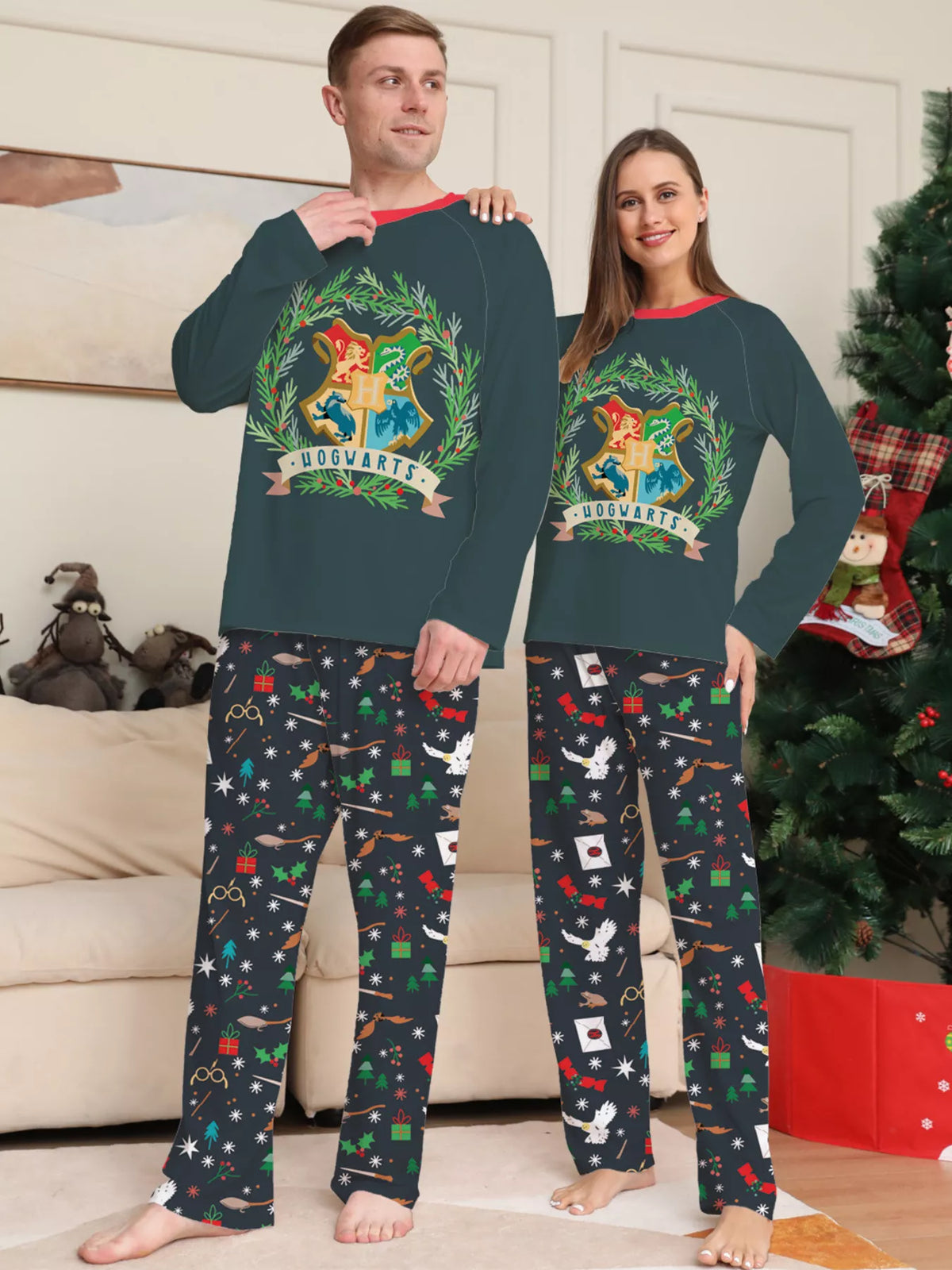 Dark green Hogwarts graphic pajama top with black patterned pants worn by an adult